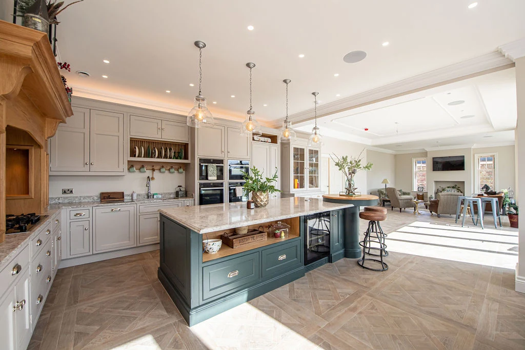 The Kenningley kitchen with a central island beneath a chandelier